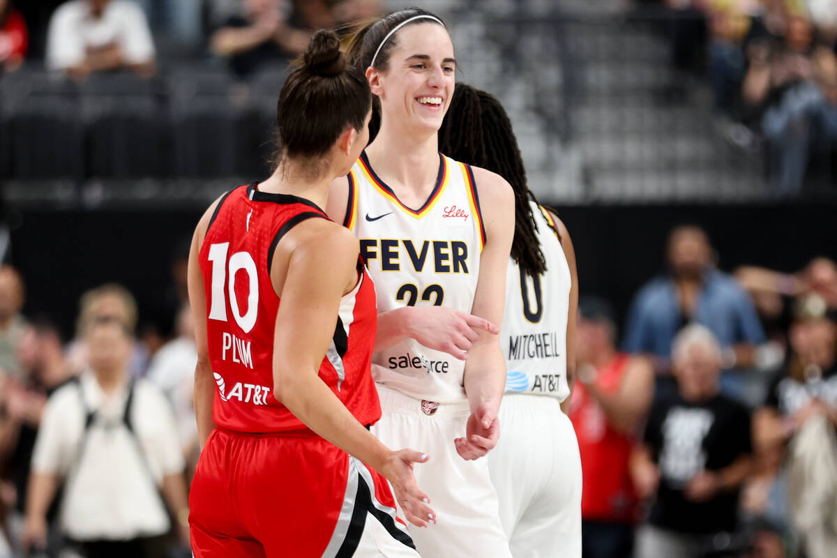 Las Vegas Aces guard Kelsey Plum (10) and Indiana Fever guard Caitlin Clark (22) laugh on the c ...