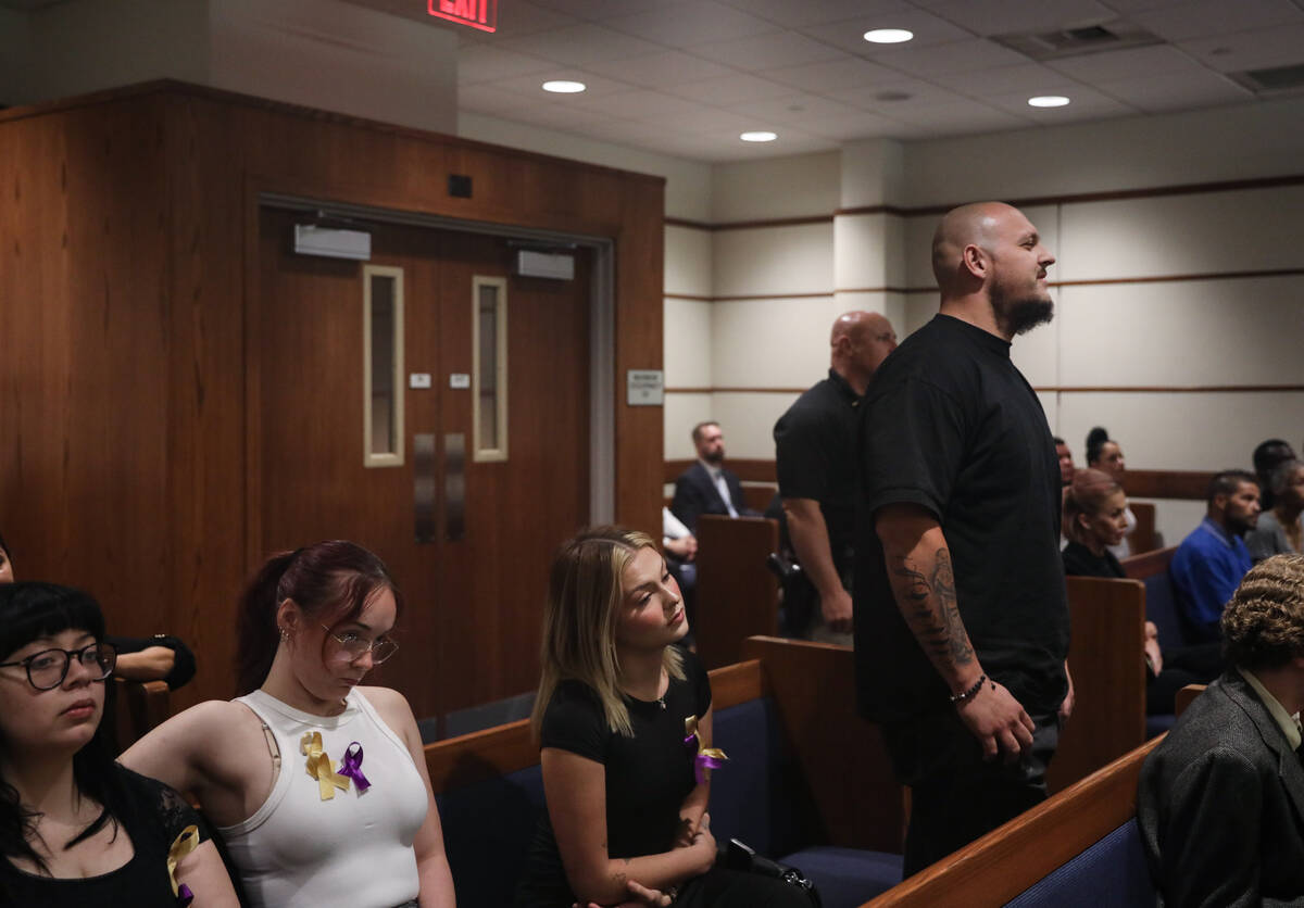 A man who declined to be named stands up next to family and friends and addresses the judge dur ...