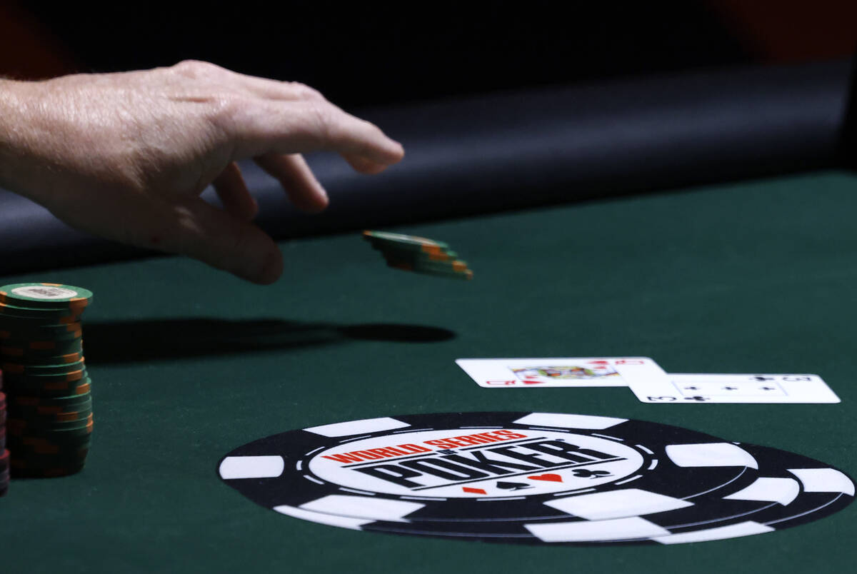 A poker player places his bet during the first day of the World Series of Poker Main Event at H ...