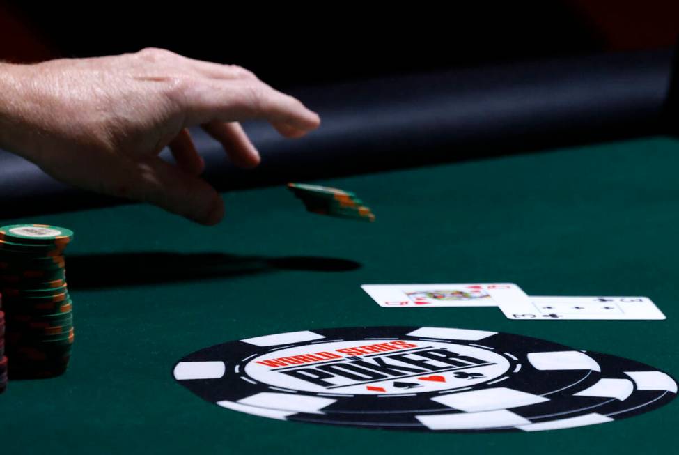 A poker player places his bet during the first day of the World Series of Poker Main Event at H ...