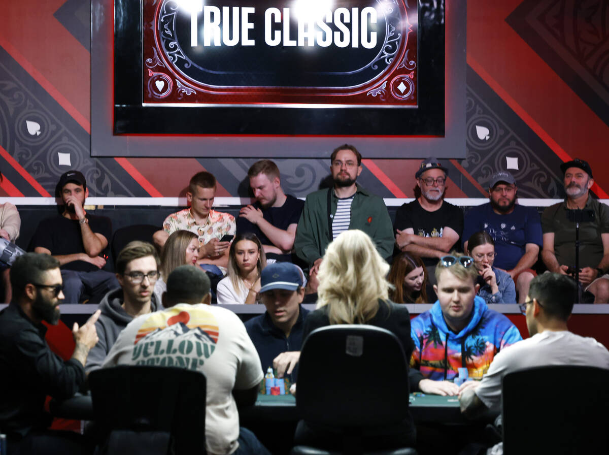 People watch poker players participate at the World Series of Poker at Horseshoe hotel-casino, ...