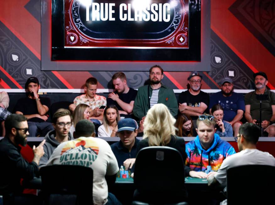 People watch poker players participate at the World Series of Poker at Horseshoe hotel-casino, ...