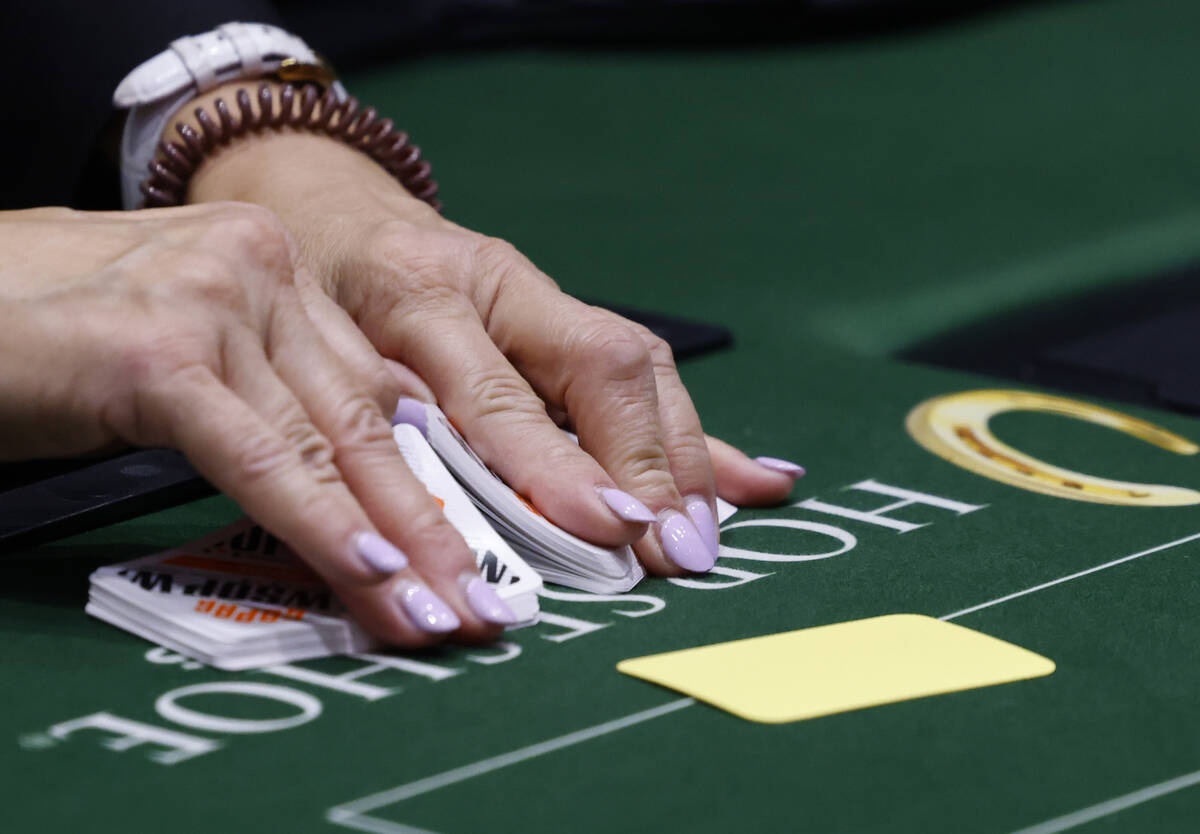 A dealer shuffles cards during the first day of the World Series of Poker Main Event at Horsesh ...
