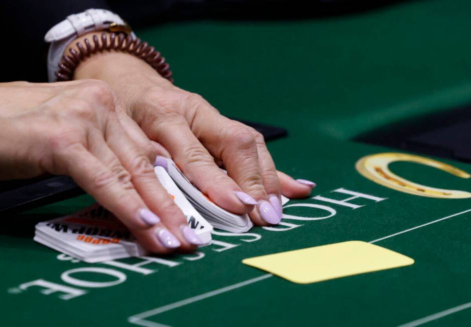 A dealer shuffles cards during the first day of the World Series of Poker Main Event at Horsesh ...