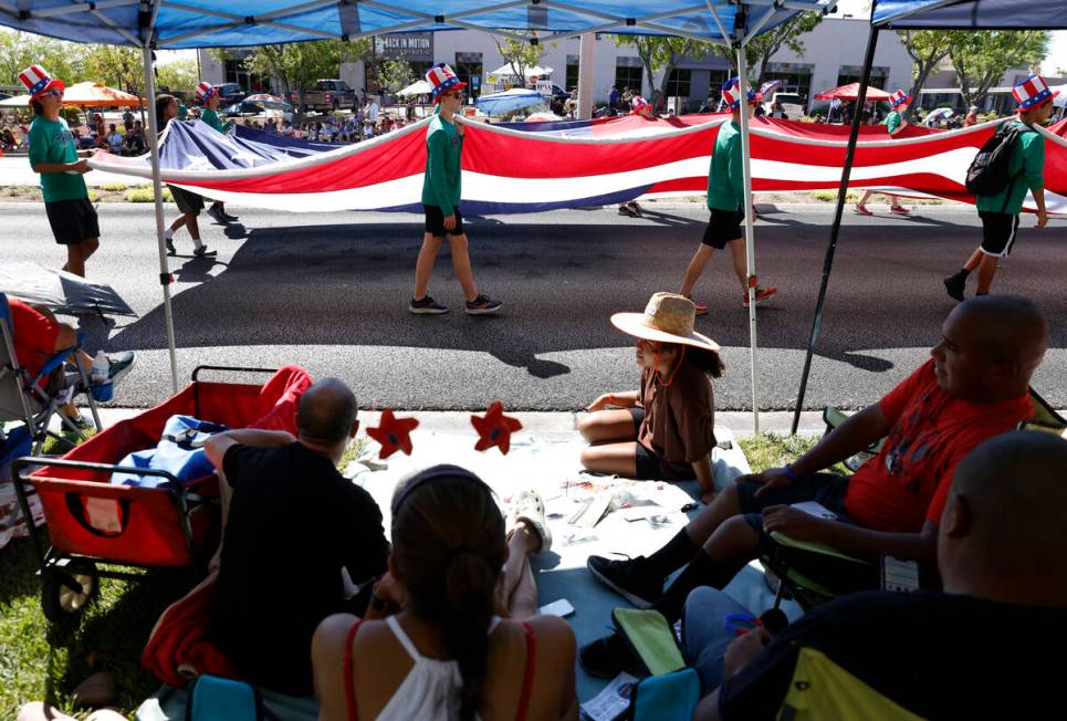 People watch as students from Palo Verde High School carry a giant American Flag during the ann ...