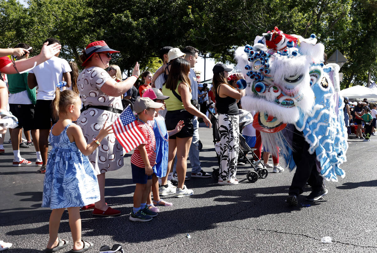 People cheer as members from Guan Strong Lion Arts participate in the the annual Summerlin Coun ...