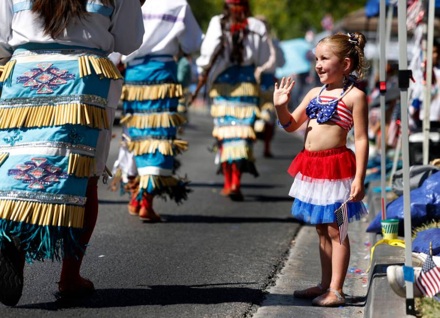 Scarlett Legrow waves as she watches the annual Summerlin Council Patriotic Parade, on Thursday ...