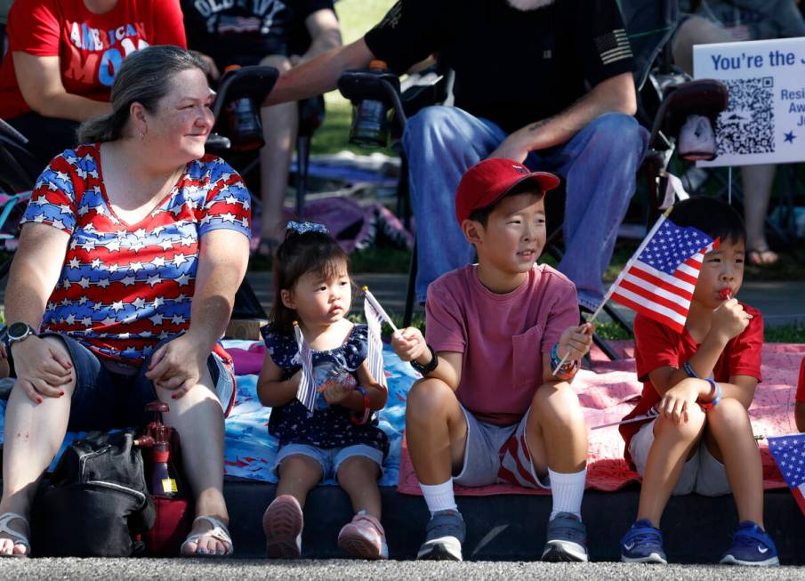 Delane Elliott, left, Elisabeth Bartlett, 2, and her brother Alex, 8, second right, watch the a ...