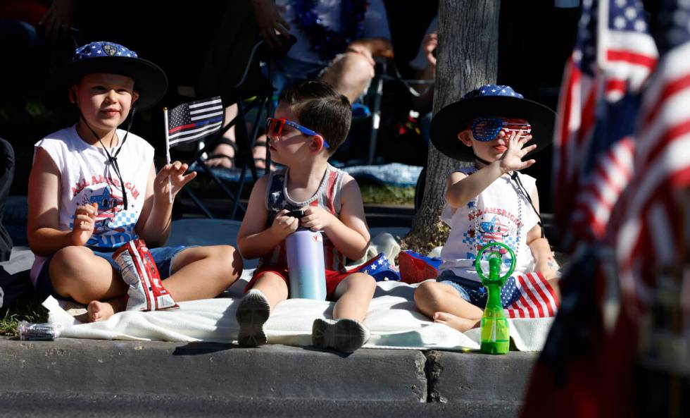 Hudson Hunter, left, 8, and his brother Caden, 3, right, watch the annual Summerlin Council Pat ...