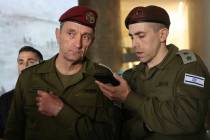 Israeli army chief Herzi Halevi, front left, listens to a message during a ceremony marking Mem ...