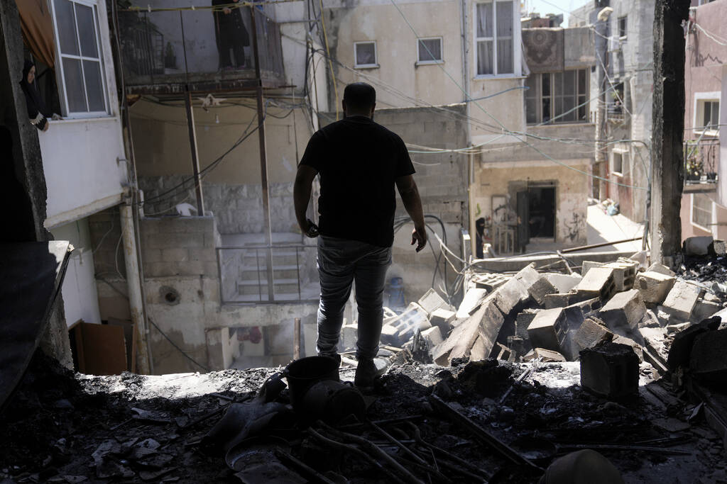 Palestinians inspect the destruction following an Israeli operation in Nur Shams refugee camp, ...