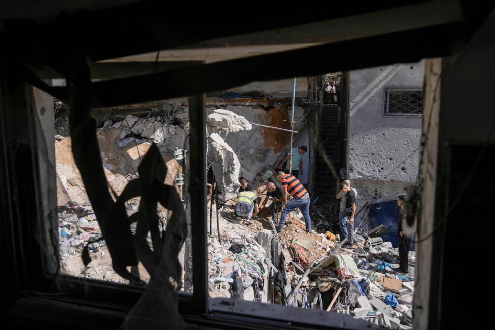 Palestinians inspect the destruction following an Israeli operation in Nur Shams refugee camp, ...