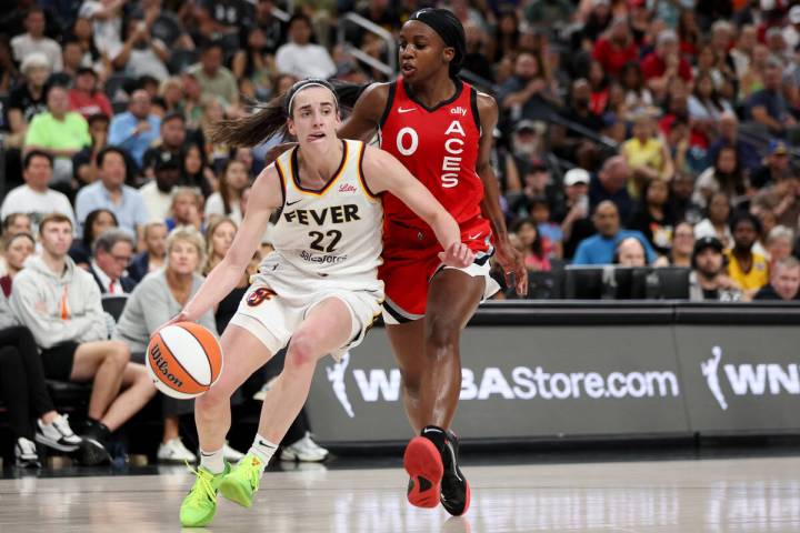 Indiana Fever guard Caitlin Clark (22) dribbles against Las Vegas Aces guard Jackie Young (0) d ...