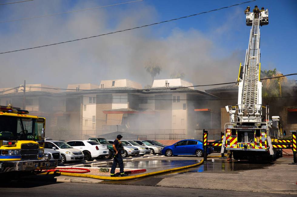 Clark County firefighters work to contain an apartment fire on Dumont Boulevard on Wednesday, J ...