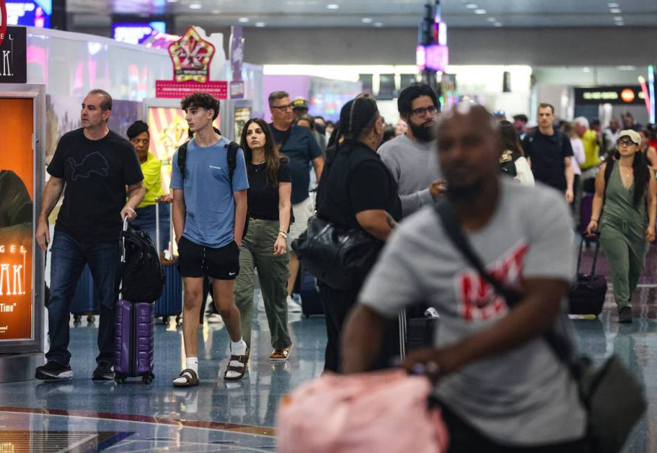 Guests pass through the baggage claim area of Harry Reid International Airport in Las Vegas, We ...