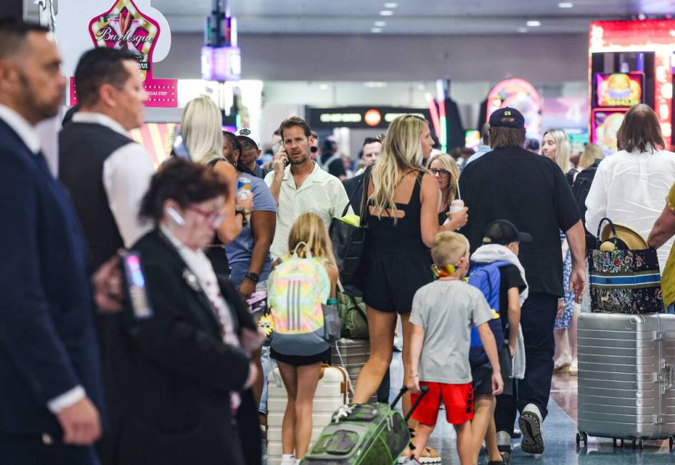 Guests pass through the baggage claim area of Harry Reid International Airport in Las Vegas, We ...