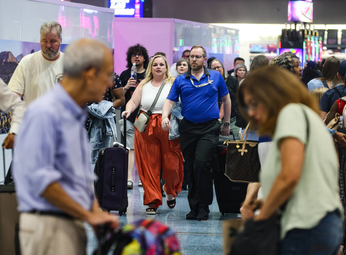 Guests pass through the baggage claim area of Harry Reid International Airport in Las Vegas, We ...