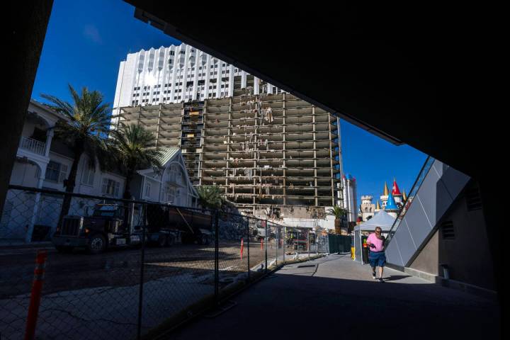 A pedestrian walks beneath a bridge as demolition continues on the Tropicana in preparation for ...