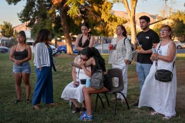 Loved ones of Alondra Rivera, 28, embrace during a vigil at Winterwood Park on Wednesday, July ...