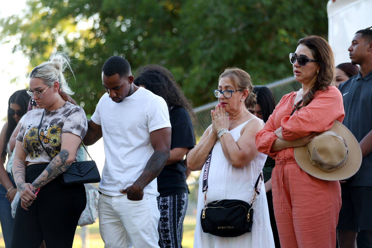 Loved ones of Alondra Rivera pray during a vigil at Winterwood Park on Wednesday, July 3, 2024, ...