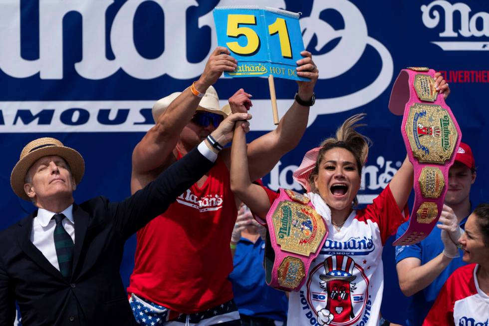 Miki Sudo, right, reacts after winning the women's division in the Nathan's Famous Fourth of Ju ...