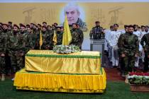 Hezbollah fighters attend the funeral procession of their comrade, senior commander Mohammad Na ...