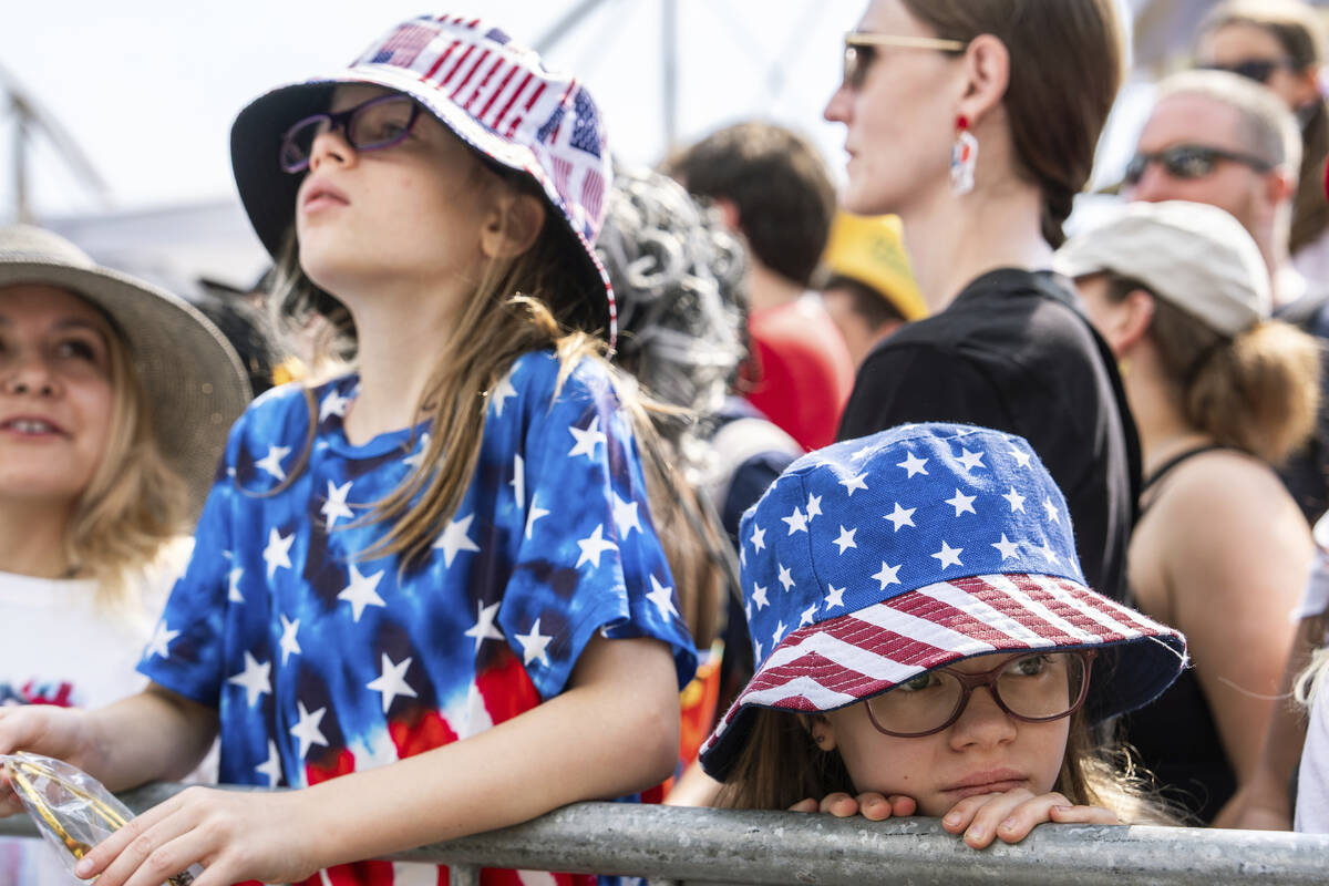 People wait for the Nathan's Famous Fourth of July hot dog eating contest to start, Thursday, J ...
