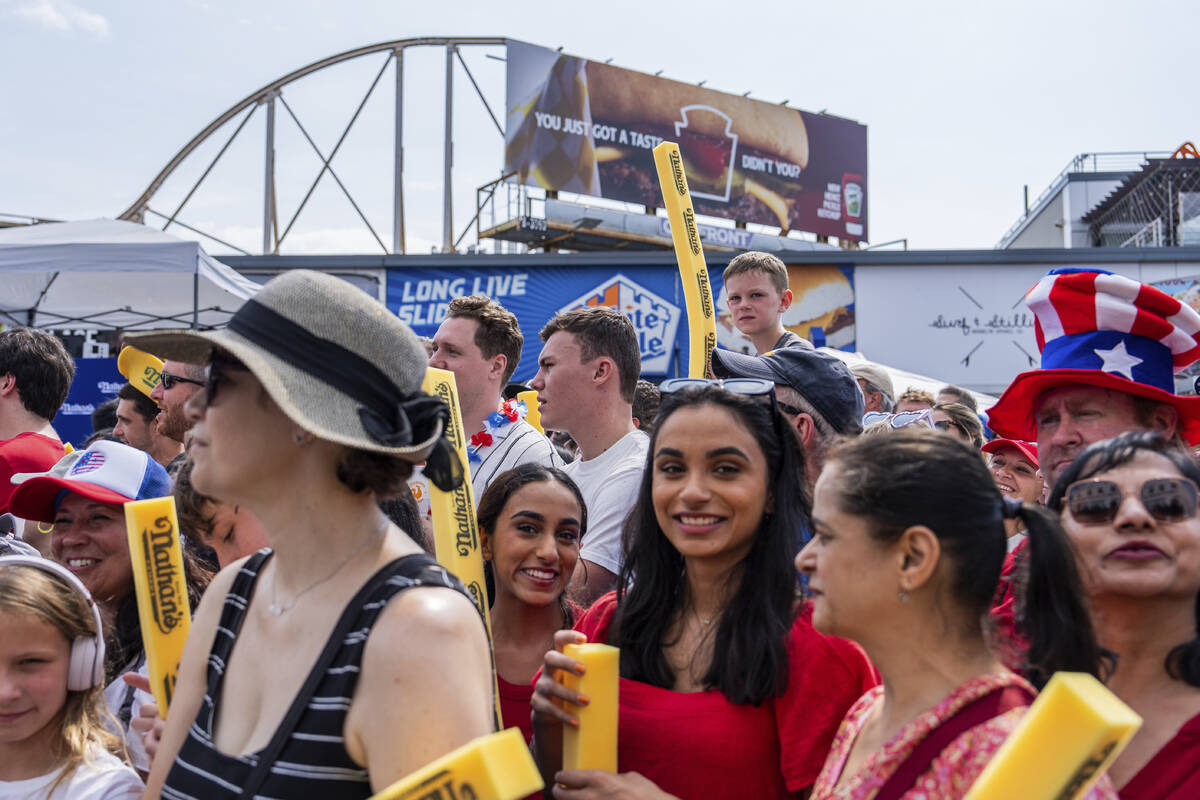 People wait for the start of Nathan's Famous Fourth of July hot dog eating contest, Thursday, J ...