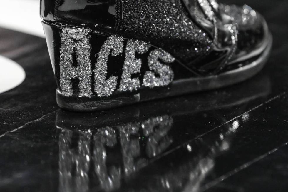 In-game announcer C.J. Simpson wears Aces-themed shoes during the second half of their WNBA gam ...