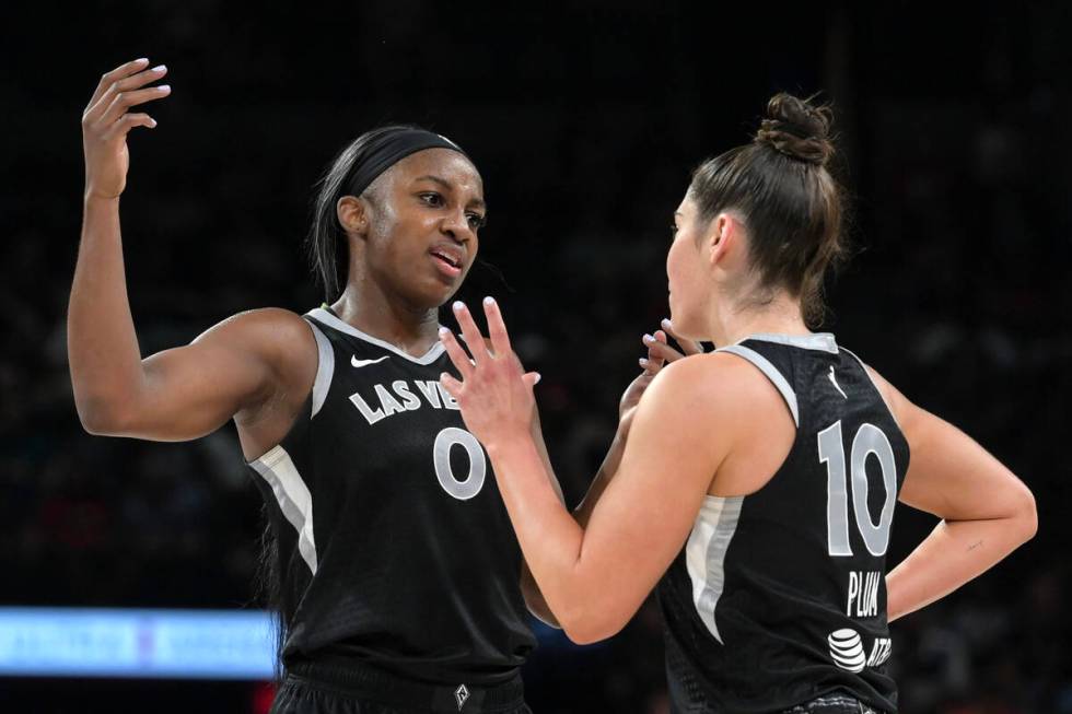 Las Vegas Aces guards Jackie Young (0) Kelsey Plum (10) confer during a break in the second hal ...