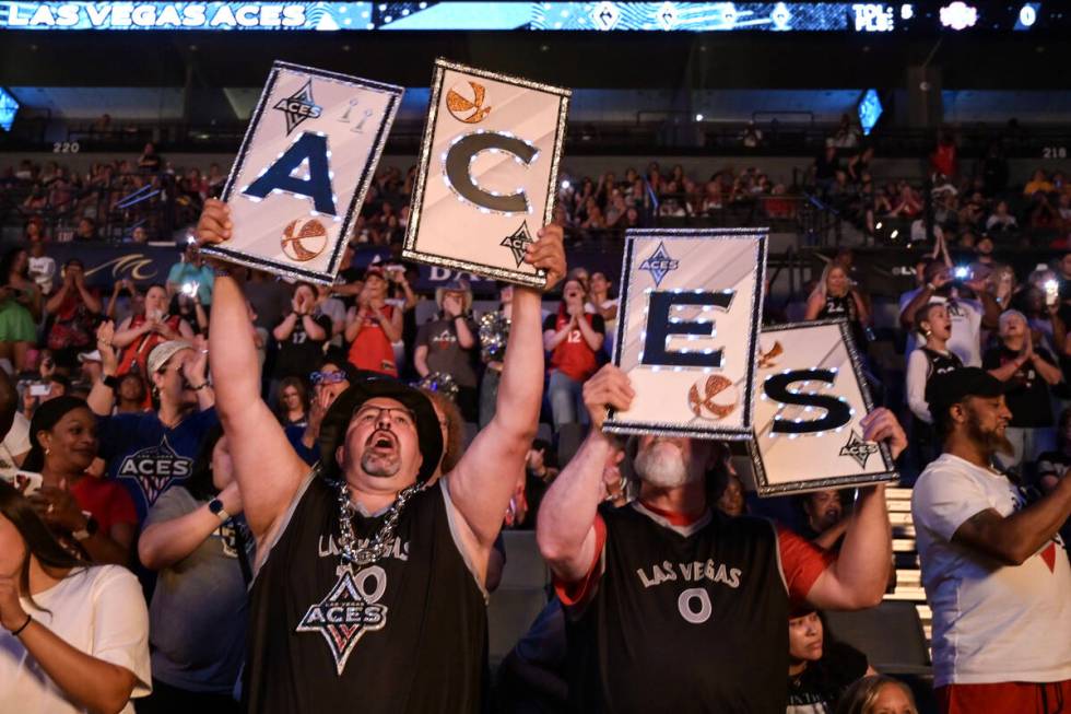 Albert Ronquillo, left, and Matt Schafer cheer on the Aces before the first half of their WNBA ...