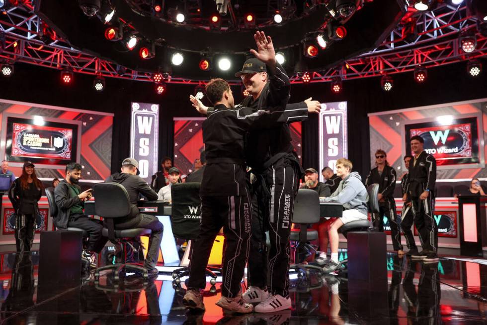 Dan Cates, left, and Phil Hellmuth embrace after their grand entrance to the World Series of Po ...