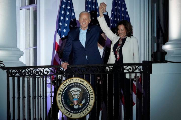 President Joe Biden and Vice President Kamala Harris join hands after they watched the Fourth o ...