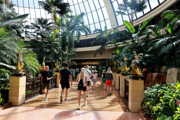 Guests walk through the atrium at The Mirage on the Strip in Las Vegas Friday, July 5, 2024. Th ...