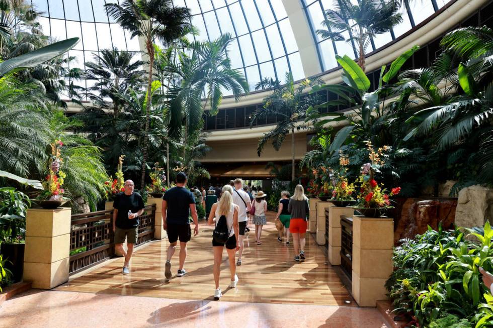 Guests walk through the atrium at The Mirage on the Strip in Las Vegas Friday, July 5, 2024. Th ...