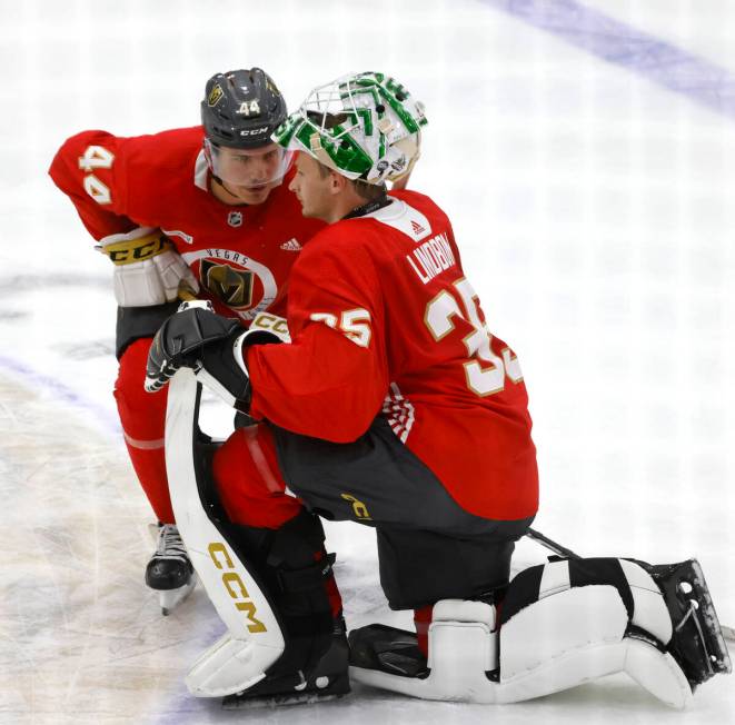 Golden Knights defenseman Christoffer Sedoff and goaltender Carl Lindbom (35) chat during team' ...