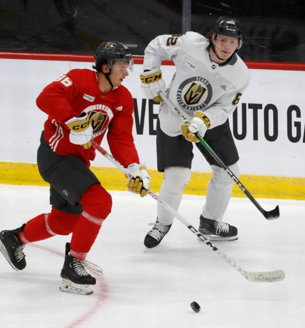 Golden Knights defensemen Samuel Mayer (96) and Abram Wiebe (82) chase the puck during team's d ...