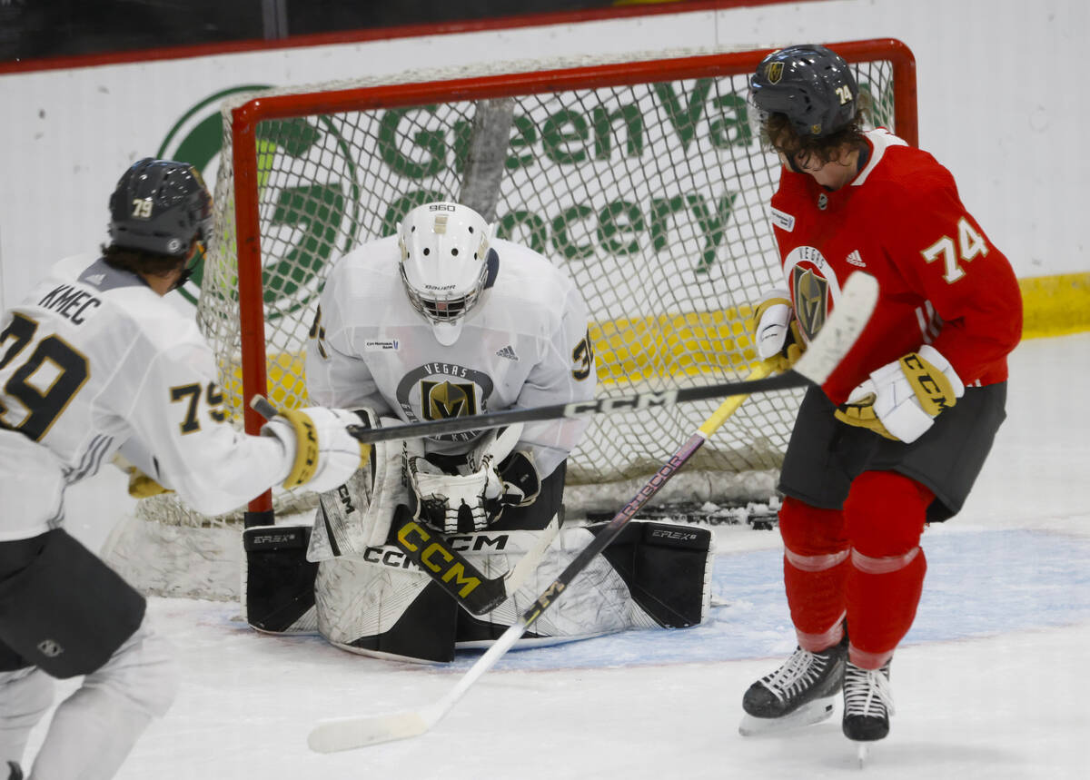 Golden Knights goaltender Jesper Vikman (32) blocks forward Shane Smith's (74) puck during team ...