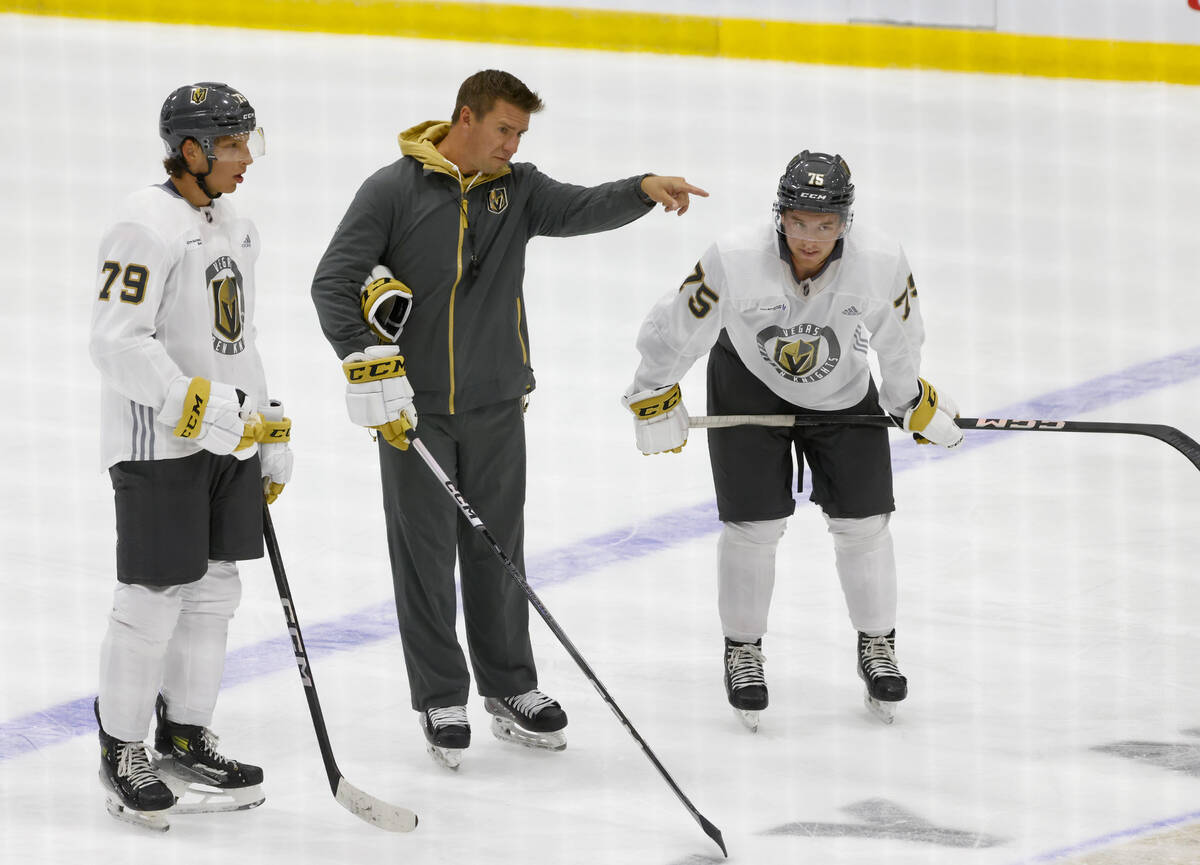 Silver Knights head coach Ryan Craig speaks to defensemen Jozef Viliam Kmec (79) and Noah De La ...