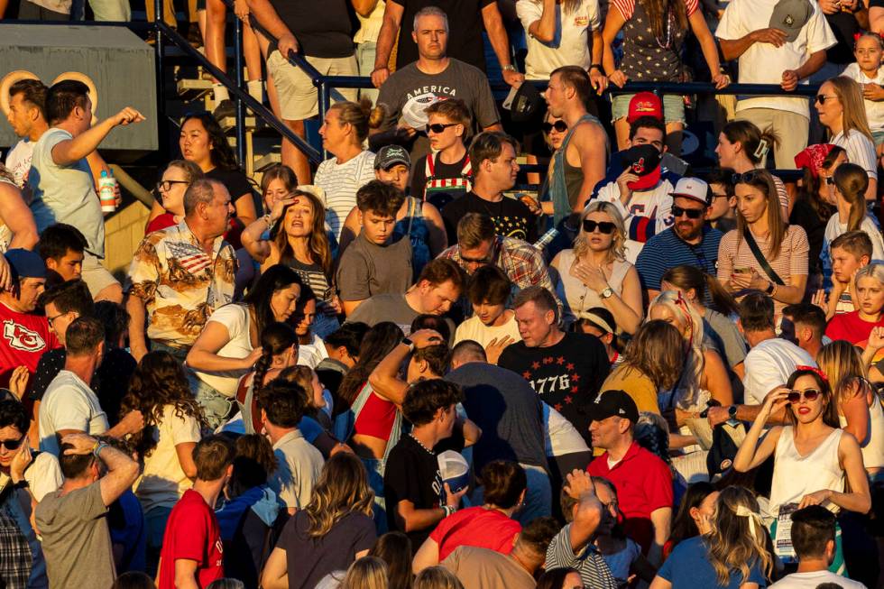 The crowd reacts after an errant firework exploded among attendees during Stadium of Fire held ...