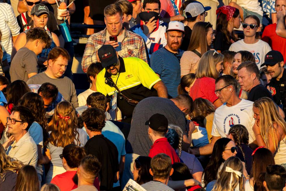 The crowd watches as a member of Provo Fire and Rescue searches for an injured individual after ...