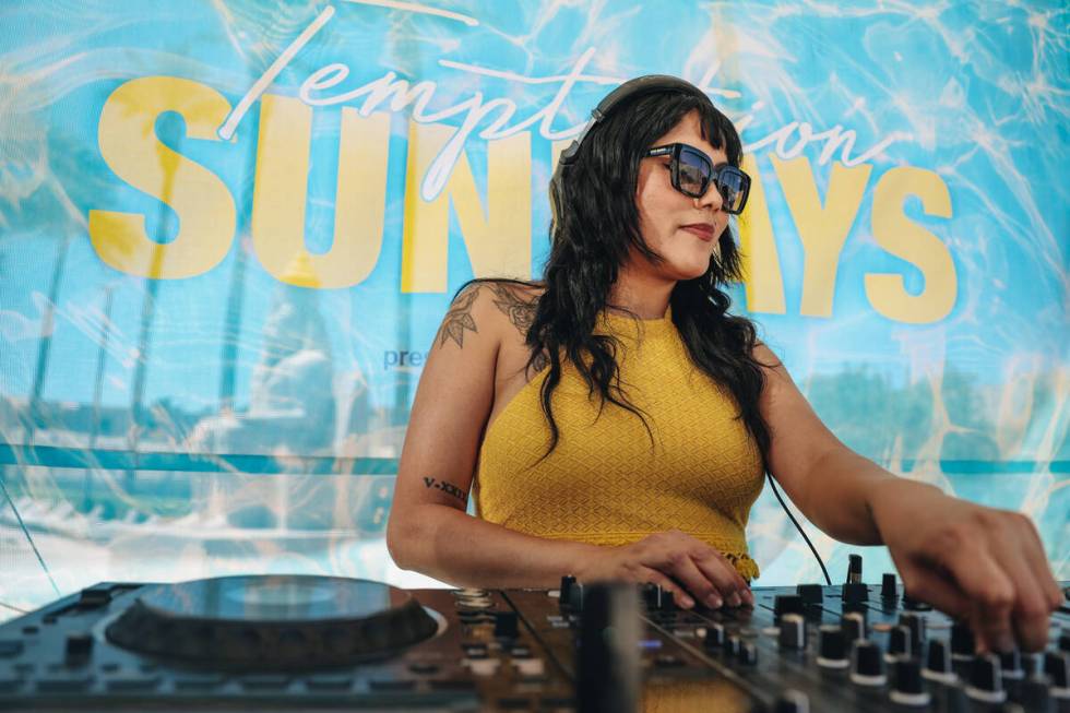 DJ Aravi DJs during Temptation Sundays, an LGBTQ+ pool party at the Luxor pool on Sunday, June ...