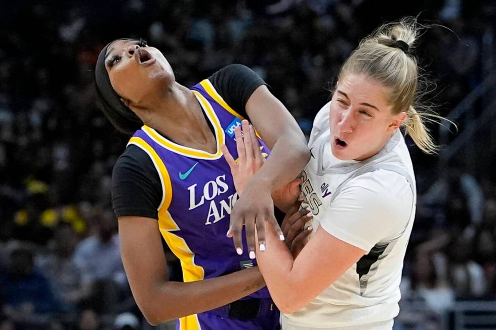 Los Angeles Sparks forward Rickea Jackson, left, and Las Vegas Aces guard Kate Martin collide d ...