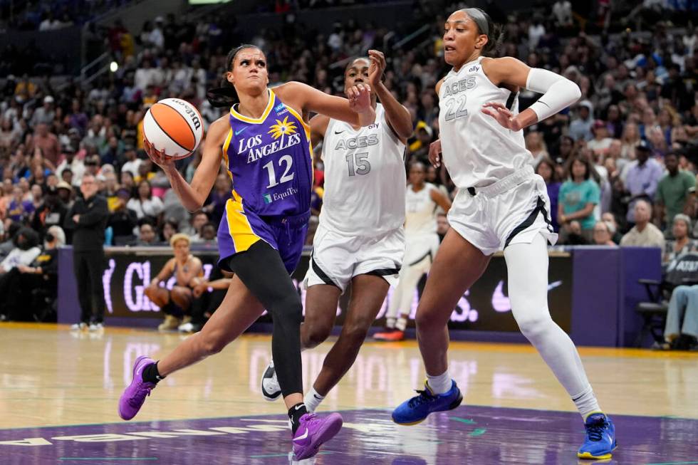 Los Angeles Sparks guard Rae Burrell, left, drives against Las Vegas Aces guard Tiffany Hayes, ...