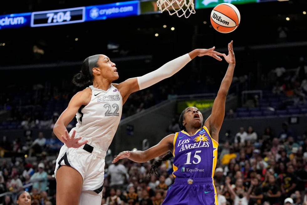 Las Vegas Aces center A'ja Wilson, left, contests a shot by Los Angeles Sparks guard Aari McDon ...