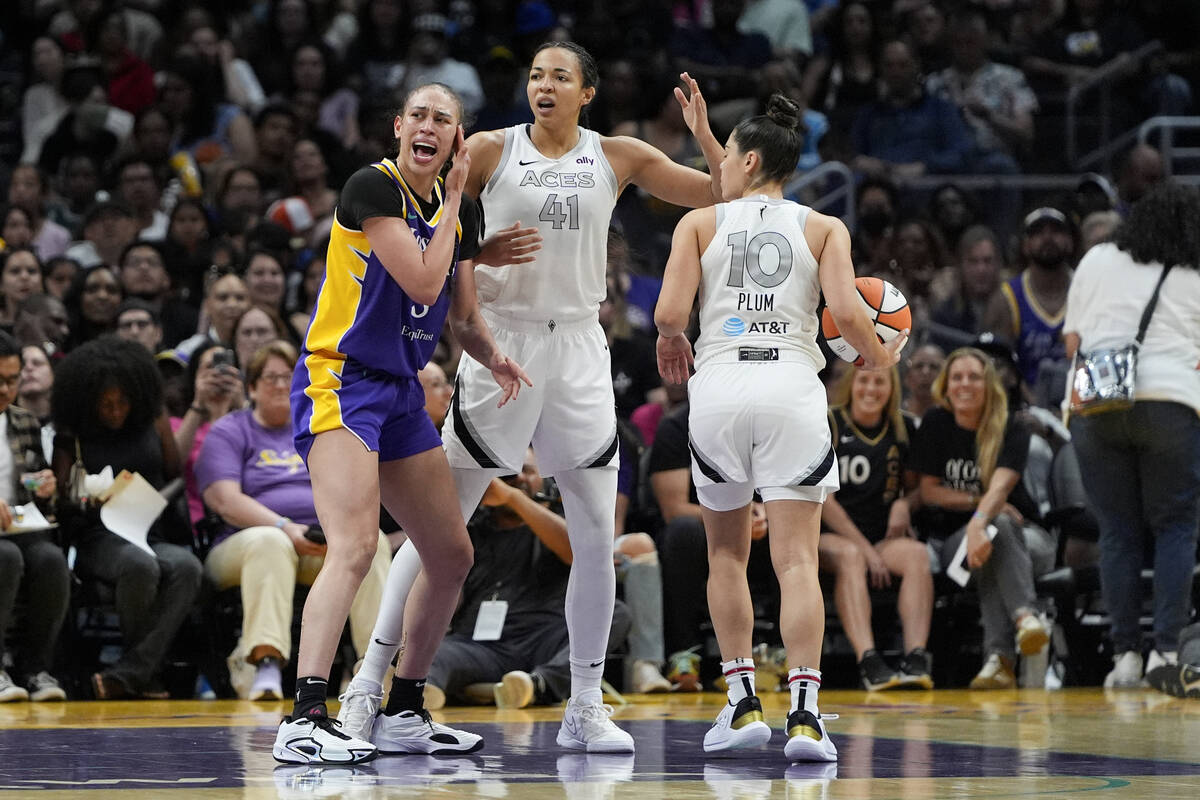 Los Angeles Sparks forward Dearica Hamby, left, reacts next to Las Vegas Aces center Kiah Stoke ...