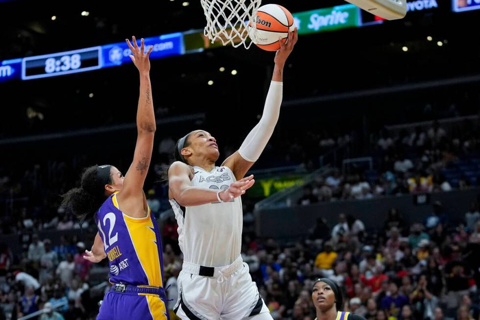 Las Vegas Aces center A'ja Wilson, right, shoots against Los Angeles Sparks guard Rae Burrell d ...