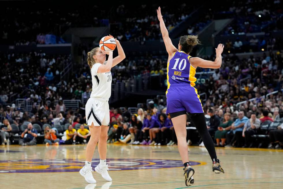 Las Vegas Aces guard Kate Martin, left, shoots against Los Angeles Sparks guard Kia Nurse (10) ...