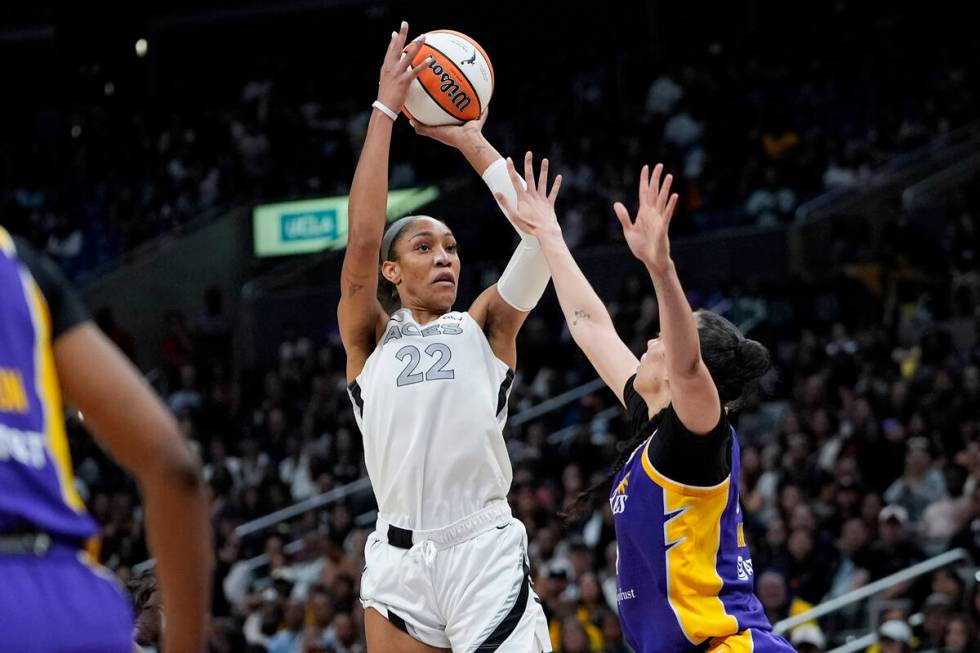 Las Vegas Aces center A'ja Wilson (22) shoots against Los Angeles Sparks forward Dearica Hamby ...