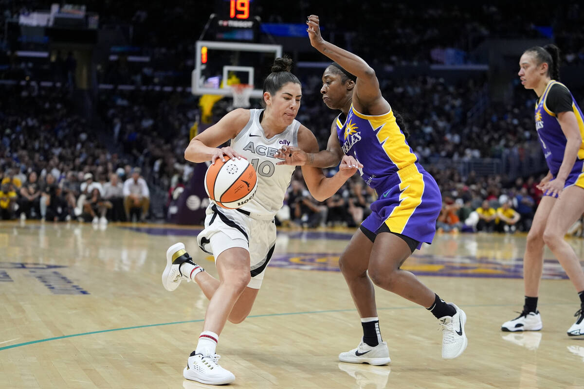 Las Vegas Aces guard Kelsey Plum (10) drives against Los Angeles Sparks guard Aari McDonald dur ...